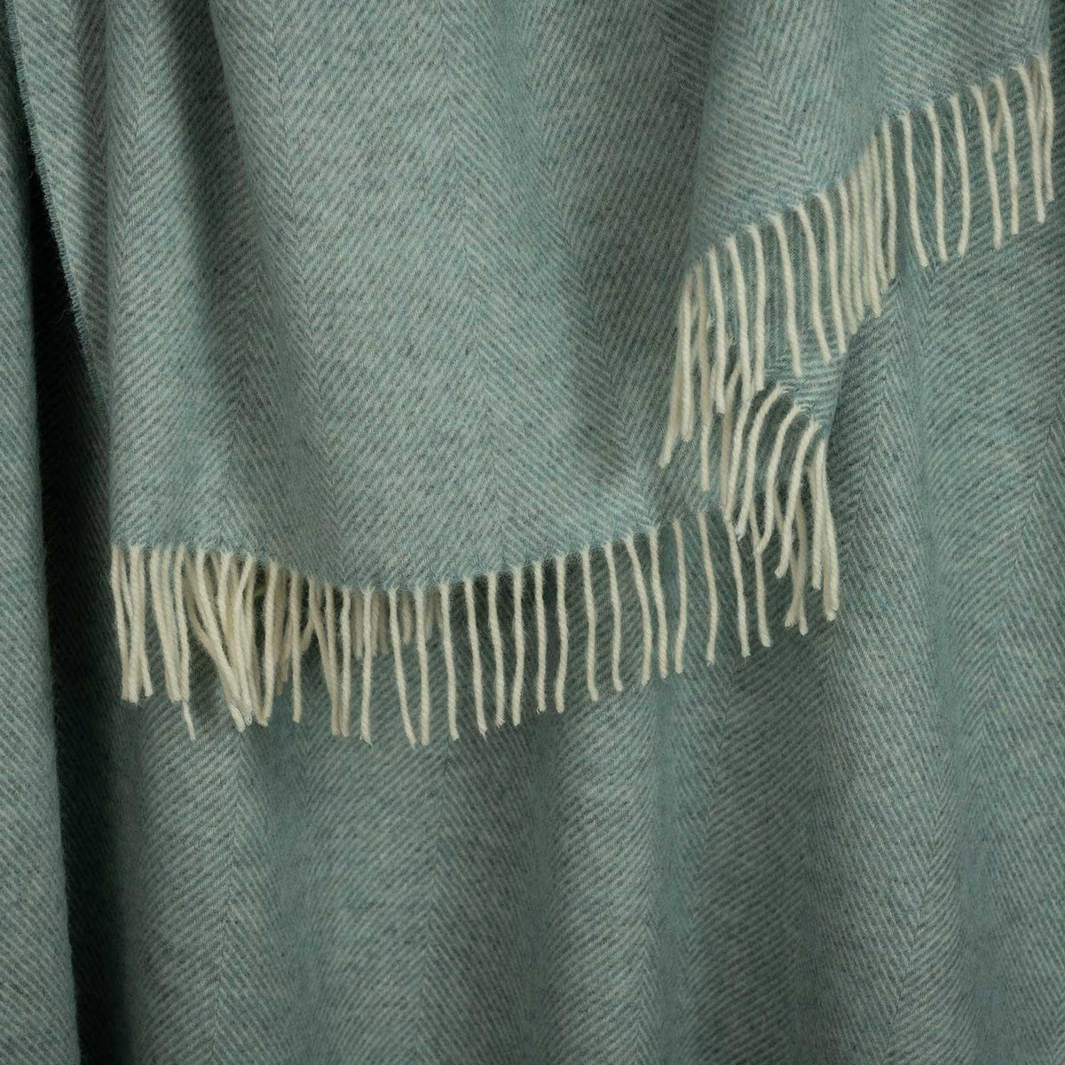 Shetland Wool Throw in Duck Egg Green, close up photo of pattern and fringe.