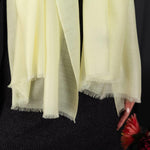 Luxuriously soft merino and silk shawl in a light yellow twill weave with a soft fine fringe generous size light and airy beautifully warm best-quality