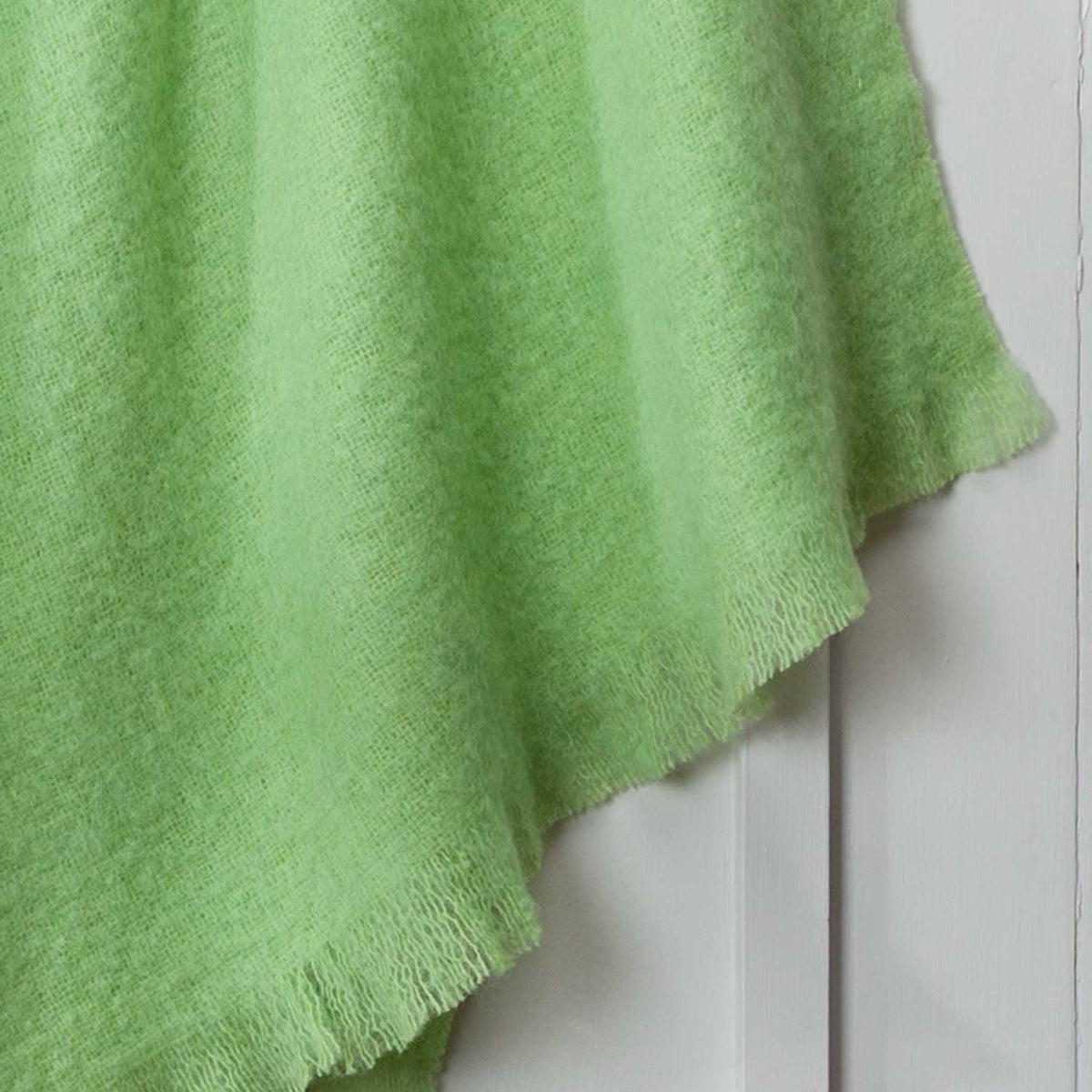 Close up of light green mohair throw.