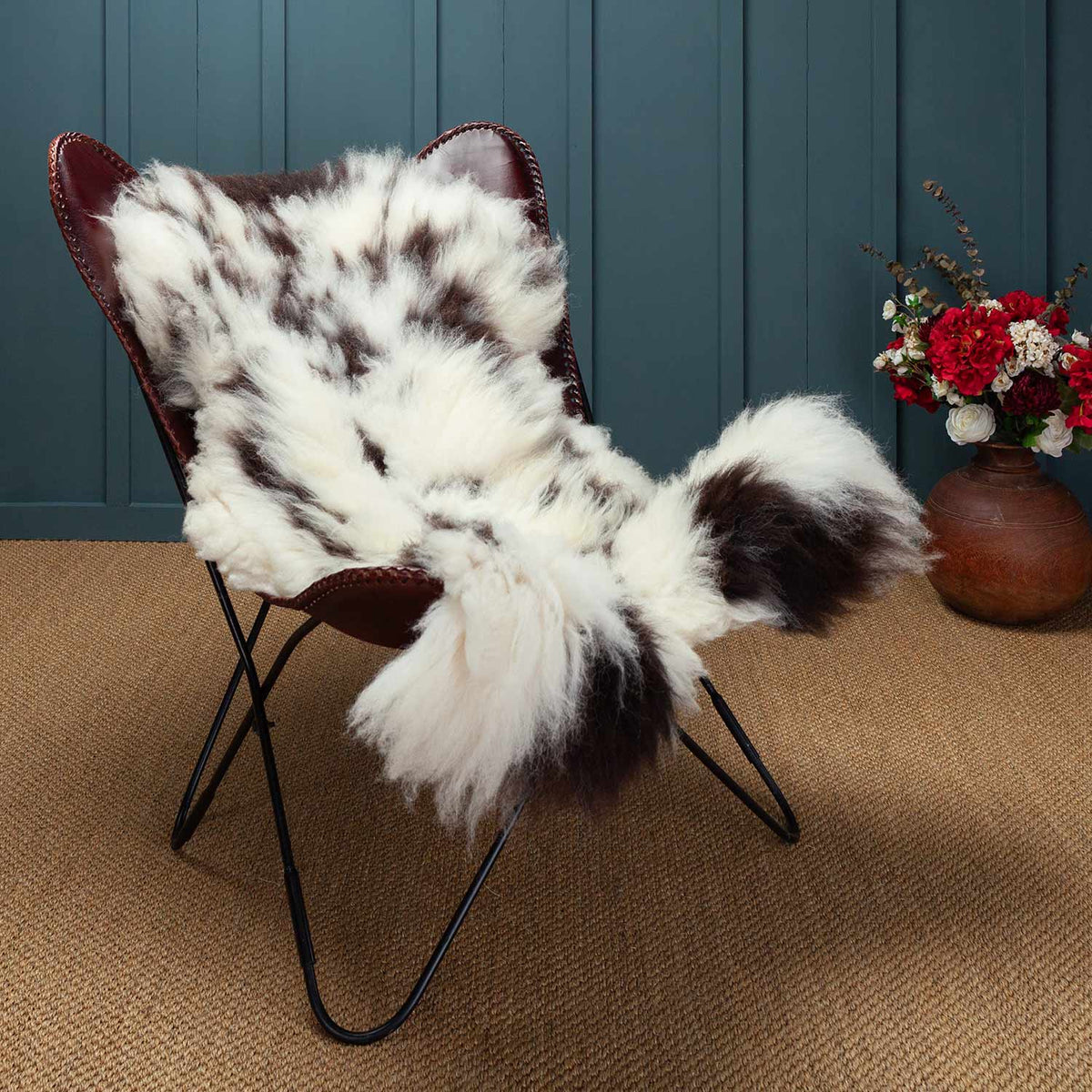 A seconds Jacob sheepskin displayed on a leather chair. This one is mostly white. 100% Natural Sheepskin, eco-tanned (chrome-free).