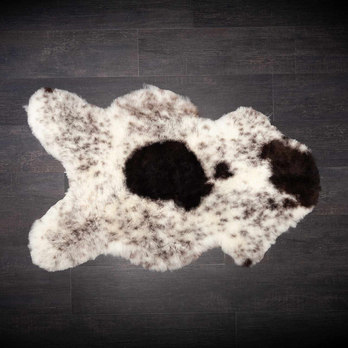 These beautiful Icelandic sheepskins are naturally dappled with soft, organic colour variations that make each piece completely unique. This one is mainly off-white speckled with dark brown and some dark brown spots. Approx size 90 x 63 CMS.