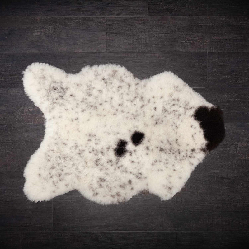 These beautiful Icelandic sheepskins are naturally dappled with soft, organic colour variations that make each piece completely unique. This one is mainly off-white speckled with dark brown and some dark brown spots. Approx size 90 x 63 CMS.