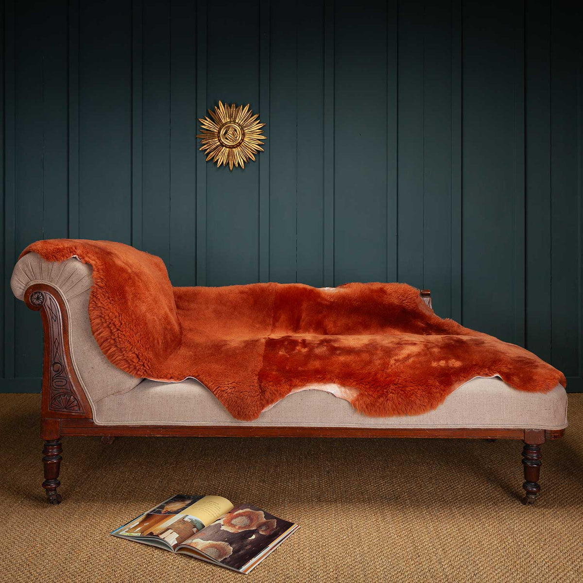 The soft, luxurious, rich ginger merino double sheepskin throw draped over a chaise longue.