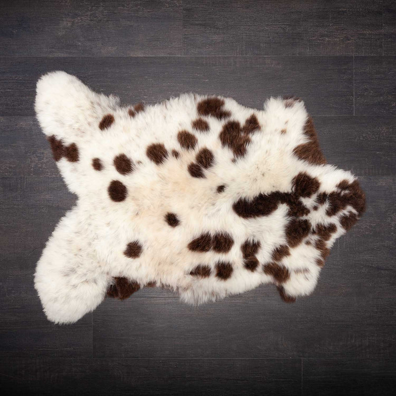 A piebald British Jacobs sheepskin,  mainly white with brown spots. Approx 90-100 x 55-65 CMS.