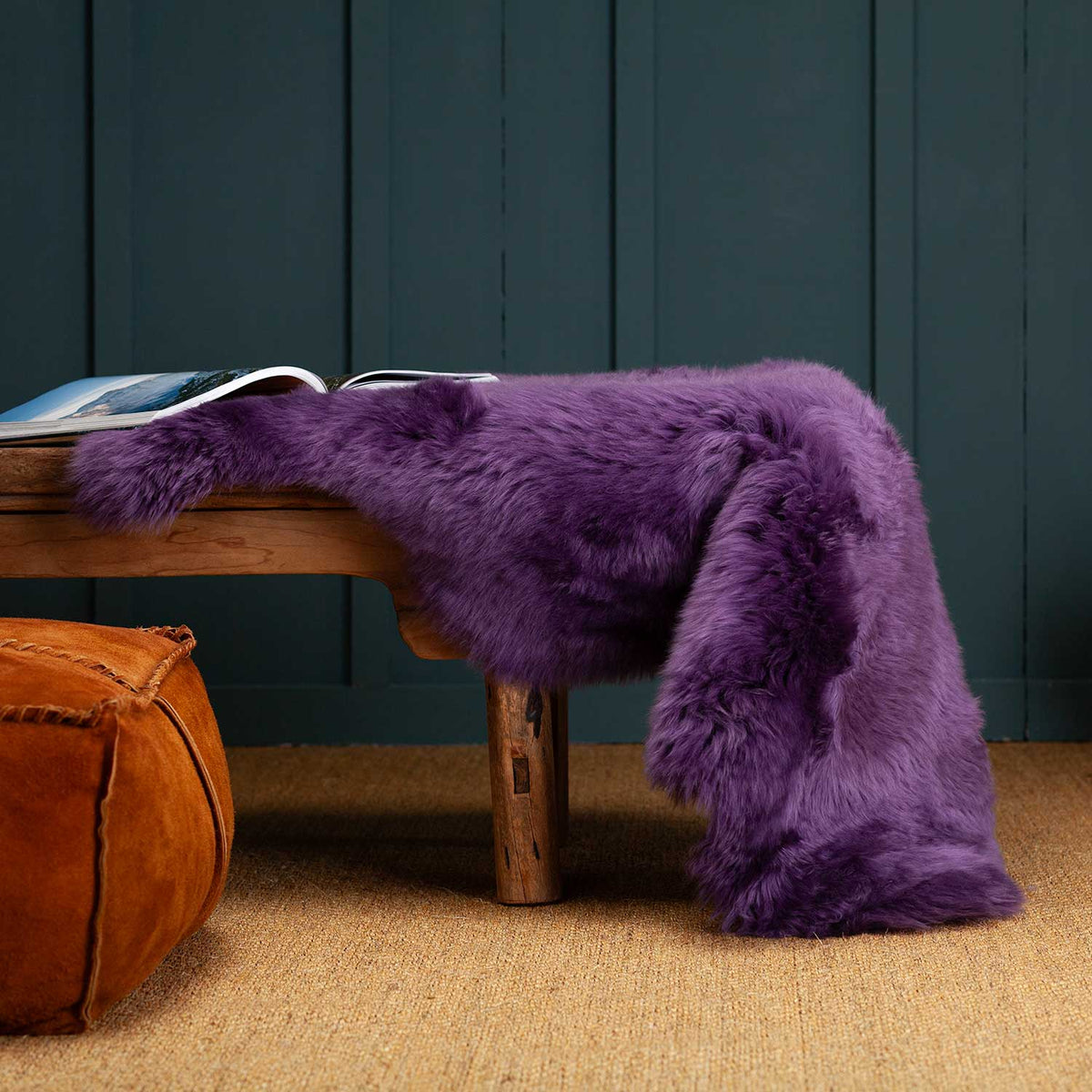 Single Sheepskin in Mulberry Mauve across a bench.