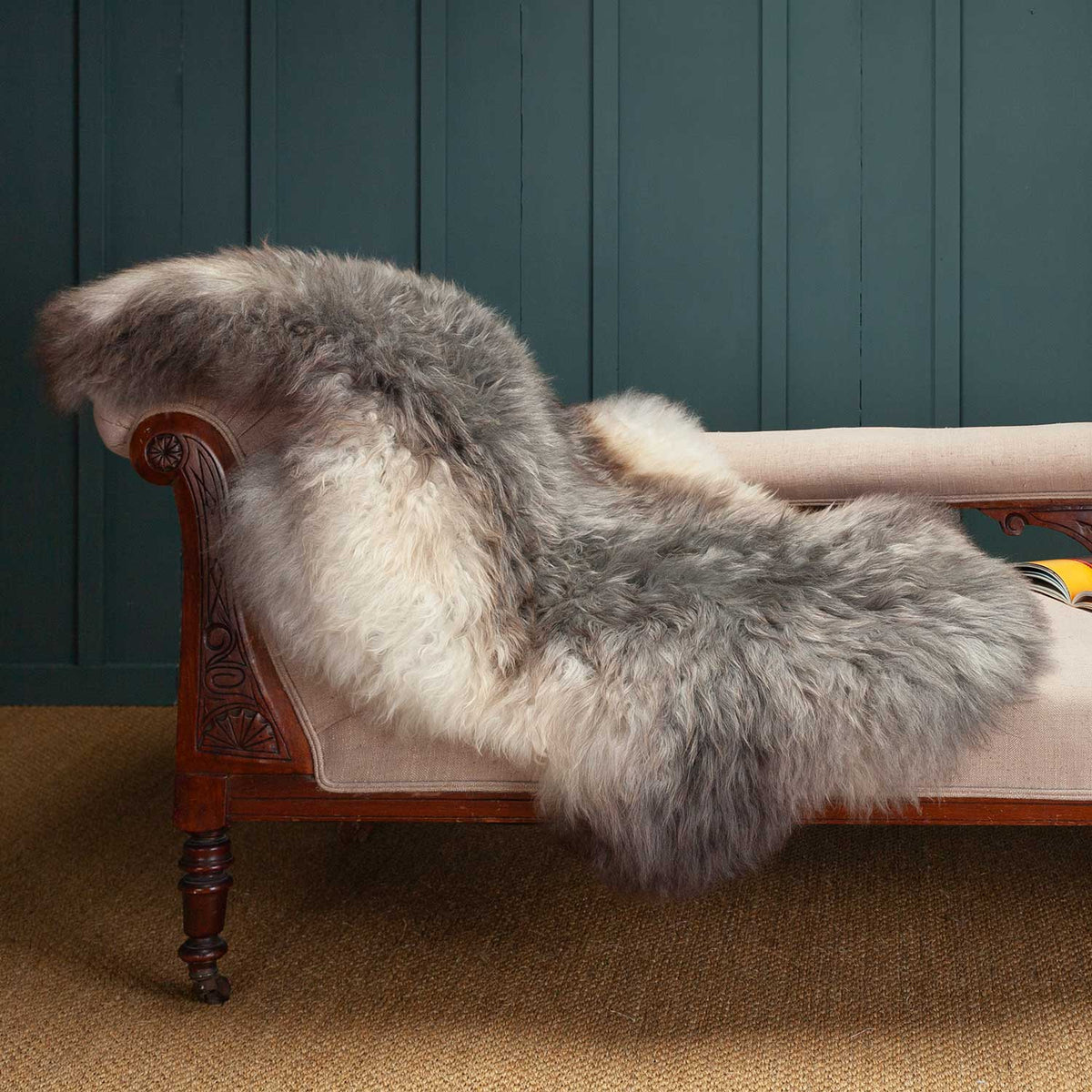 Extra large Swedish sheepskin in rich tones of brown, grey and cream, draped over a chaise longue. 100% Rare Breed Sheepskin.