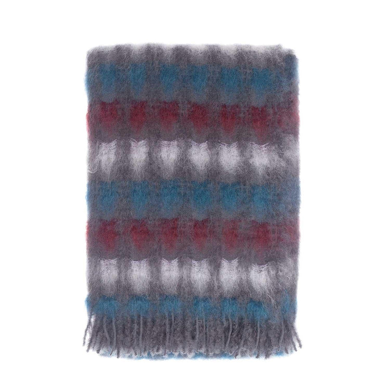 A grey, blue, red and white blanket made from a blend of Mohair and extra fine Merino wool, finished with a grey tasselled fringe. Size 130 x 200 CMS.
