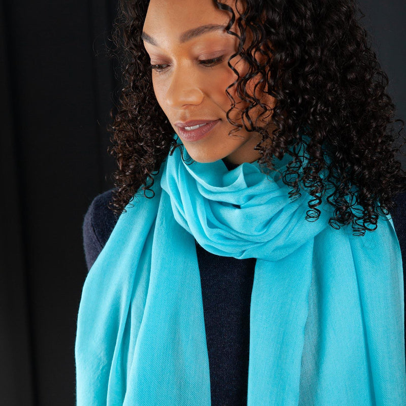 Ultrafine Ring shawl in turquoise, spun from a gorgeously lightweight and fine fabric, worn looped around the neck like a scarf. Made in Nepal. 90 x 200 CMS.