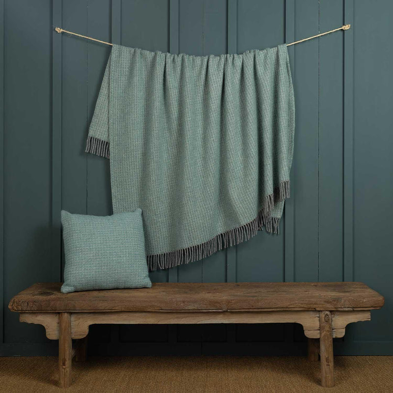 Aqua and grey pure new wool cushion in a contemporary textured weave. Shown with the matching throw. Size 50 x 50 CMS.