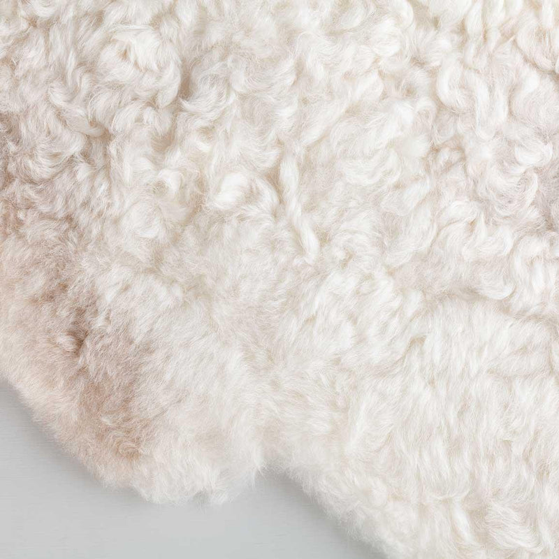 Undyed, shorn Icelandic sheepskin, greys, and browns flecked through a natural white soft fleece, Eco tanned real sheepskin