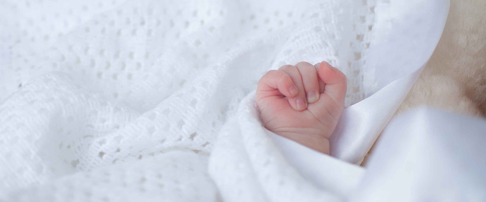 Cellular baby blankets, woven from pure, softest cotton or lambswool with a satin binding or stitched edge in white or ivory.