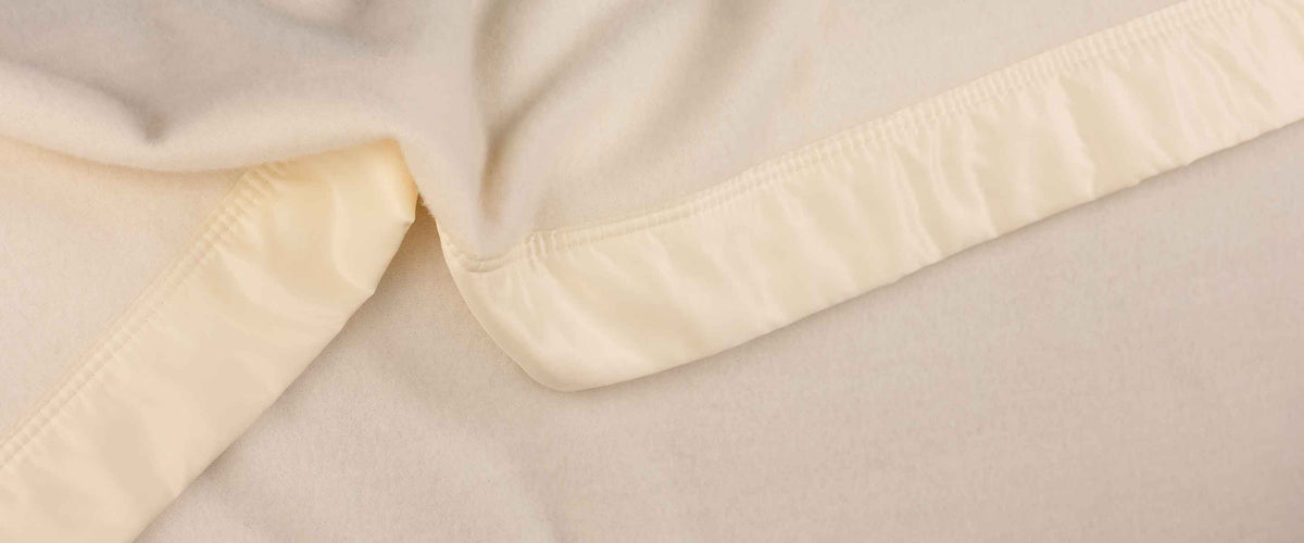 Traditional high-quality John Atkinson bed blankets made from British wool in the UK, various colours, weights, and styles.