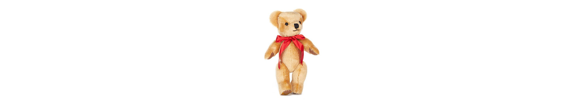  London Gold handsome in his red bow, stands at 12 inches tall. Fully jointed; soft golden mohair, with oak-brown felt paws.