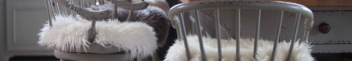 Soft, dense sheepskin seat pads and cushions in neutral shades and varying styles for chairs, benches, sofas, and wheelchairs