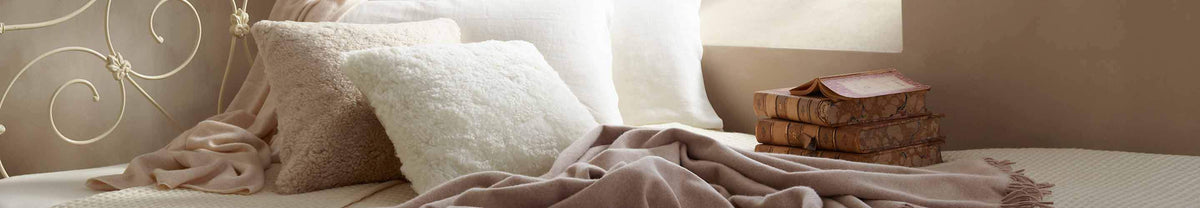From cute sheepskin doorstops, cuddly hot water bottles, stylish and soft footstools and cushions to baby gifts and pet beds