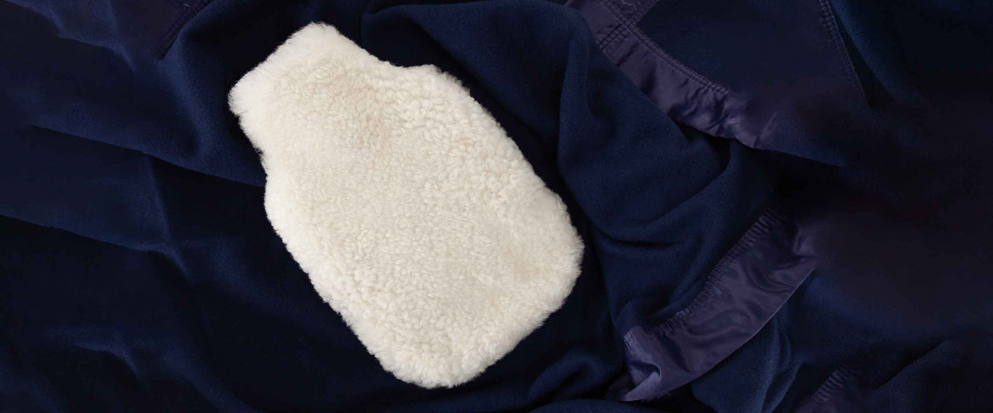 From cute sheepskin doorstops, cuddly hot water bottles, stylish and soft footstools and cushions to baby gifts and pet beds