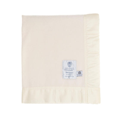 A finely woven, cream, pure Merino wool baby blanket, bound on all four sides with a silky cream satin trim. Made in England.