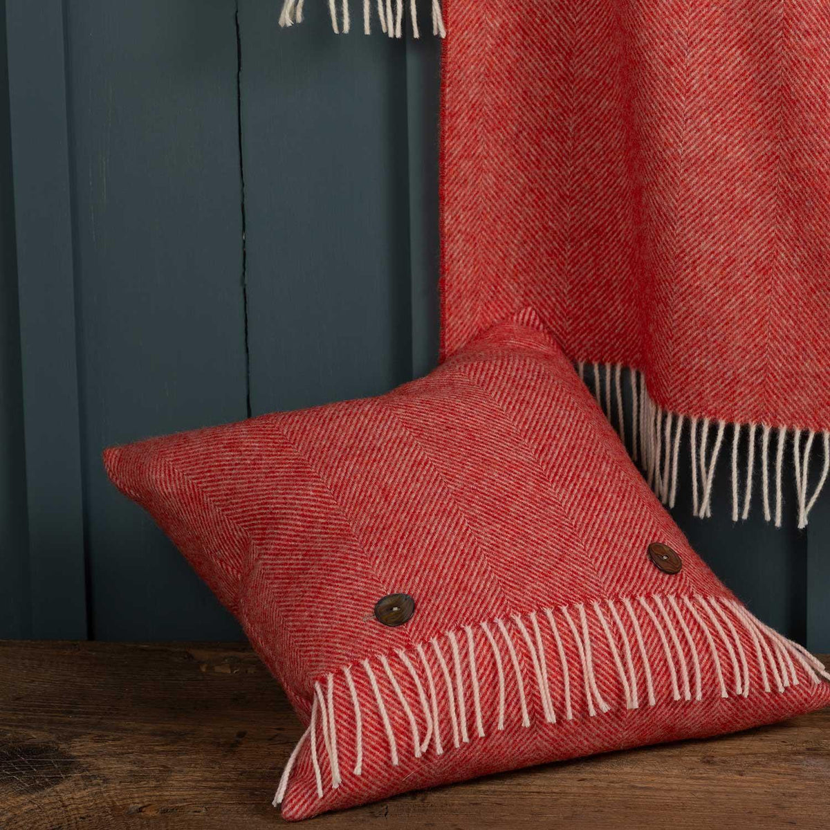 Shetland wool herringbone cushion in coral red, shows matching throw (available separately whilst stock  lasts), cushion size is   40 CMS by 40 CMS.