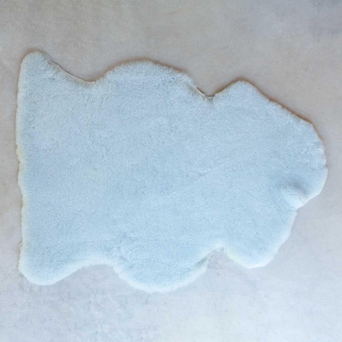 Light blue sheepskin rug, soft short fleece, average size is 115 CMS X 70 CMS. 