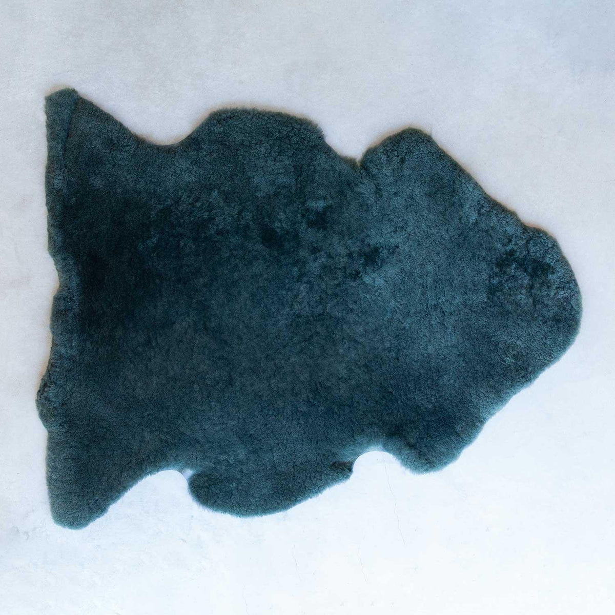 Sheepskin rug in dark green, soft with short fleece, average size is 115 CMS X 70 CMS.