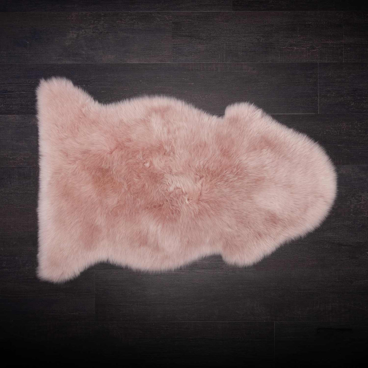 Single sheepskin rug in Dusky Rose, Very soft and tactile, medium length fleece, size is 95 CMS by 65 CMS.