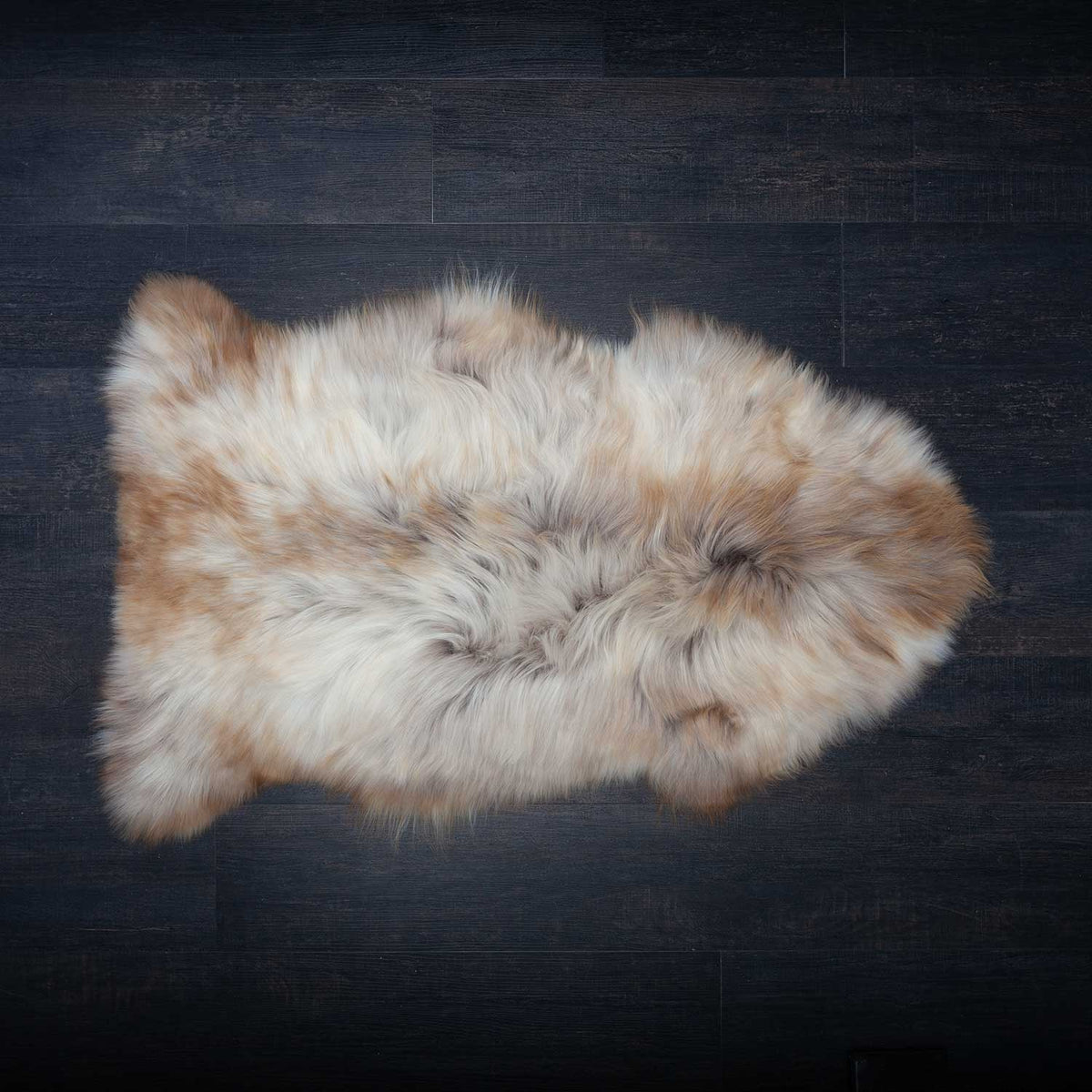 Natural Undyed Himalayan Sheepskin Rug in mix of creams and browns. The fleece is fine, silky and lightweight, with a fleece length of up to 10CMS. Approx size 85-98 × 50-65 CMS.