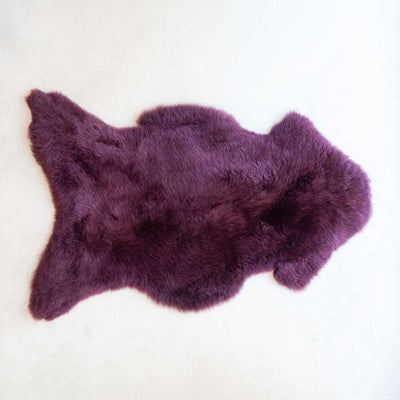 Purple fur rug on a white background