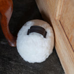 Sheepskin Doorstop in white curly sheepskin with dark brown leather carry handle