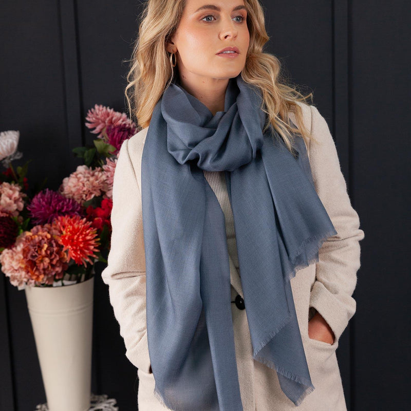 Luxuriously soft merino and silk shawl in storm cloud blue grey twill weave with a soft fine fringe generous size light and airy beautifully warm best-quality By The Wool Company