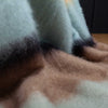 A close-up highlighting the cool coastal tones of pale green, blue, yellow and brown. Made in Spain.