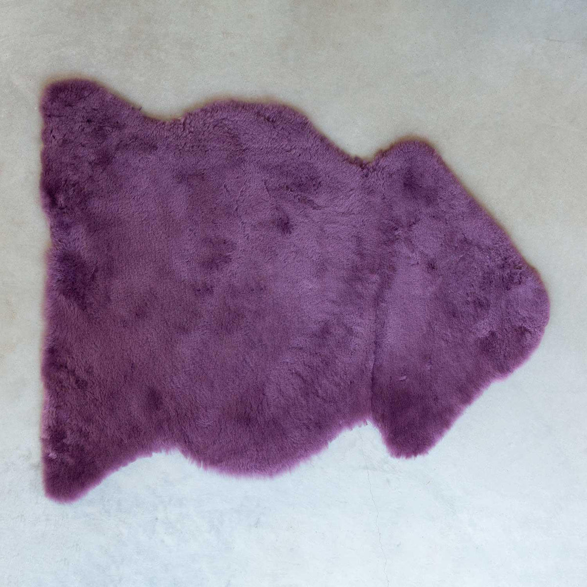 Heather coloured sheepskin soft with  short fleece, average size is 115 CMS X 70 CMS.