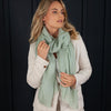Luxuriously soft merino and silk shawl in sage light green twill weave with a soft fine fringe generous size light and airy beautifully warm best-quality By The Wool Company