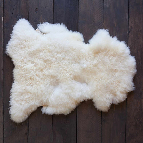 Soft, thick, & supportive British economy sheepskin pet bed or economical rug in natural creamy tones By The Wool Company