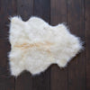 Soft, thick, & supportive British economy sheepskin pet bed or economical rug for the home or garden in natural creamy tones