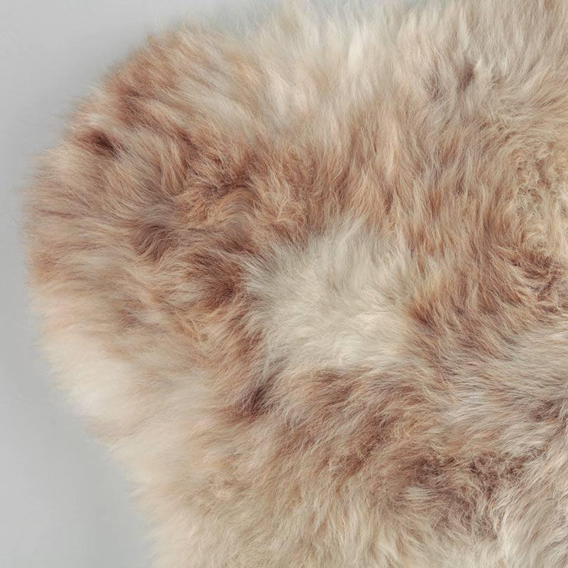 Subtle flecks of coffee browns running through a light-coloured creamy fleece. Soft and silky genuine British sheepskin.