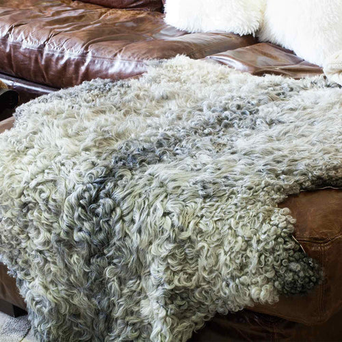 Natural XL sheepskin undyed colour encompassing every shade of grey and cream. luxurious fleece, short, curly, and very soft.