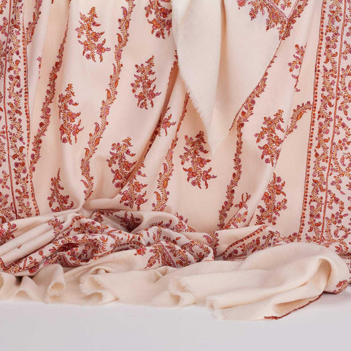 Hand-crafted 100% cashmere pashmina embroidered with orange pink and gold thread on a neutral background finest-quality