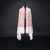 Hand-crafted 100% cashmere pashmina embroidered with orange pink and gold thread on a neutral background finest-quality