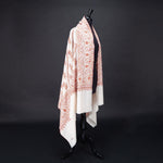 Hand-crafted 100% cashmere pashmina embroidered with orange pink and gold thread on a neutral background finest-quality