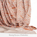 Hand-crafted 100% baby cashmere pashmina embroidered with orange red & gold thread on a neutral background finest-quality
