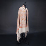 Hand-crafted 100% baby cashmere pashmina embroidered with orange red & gold thread on a neutral background finest-quality