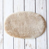 Silky soft, thick, & supportive luxury shorn dyed small sheepskin oval pet bed in attractive colours for a cat or small dog
