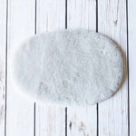 Silky soft, thick, & supportive luxury shorn dyed small sheepskin oval pet bed in attractive colours for a cat or small dog