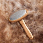 The Wool Company - Luxury Sheepskin Brush - Beautifully designed with sleek bamboo handle and head. Long stainless steel curved tines that get right through the fleece. Helps to keep your sheepskin looking its best.
