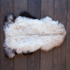 Luxurious, thick long white fleece, strikingly outlined with black and/or dark brown around the edges. Quality British hide.