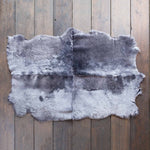Quad-size sheepskin throw in shades of grey, silver, and charcoal. Extremely soft & beautifully finished. By The Wool Company