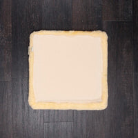 Natural creamy colour lambskin wheelchair cushion providing all-year-round comfort & support while using any chair